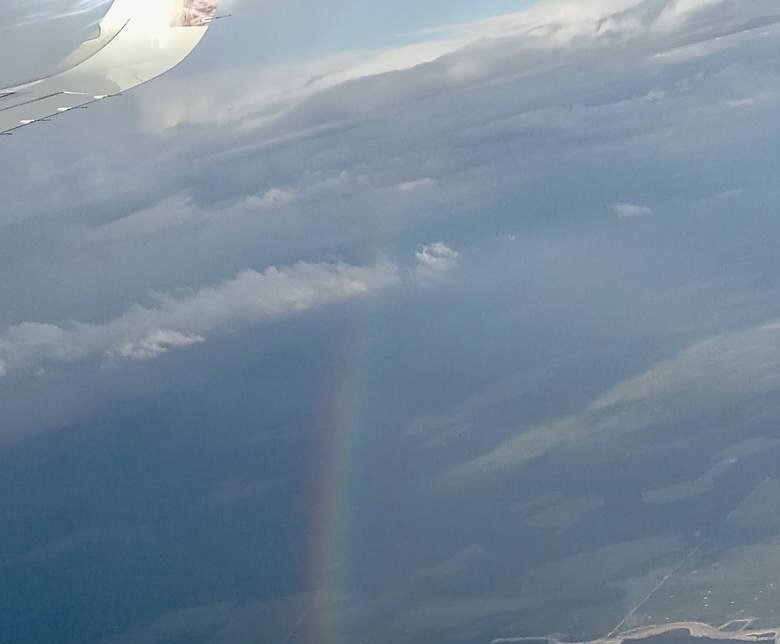 A rainbow from the plane window, May 13, 2022.